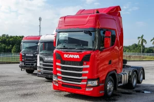 3 new Scania trucks lined up in a parking lot