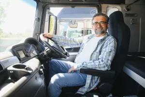 Truck driver sitting behind the wheel of his truck