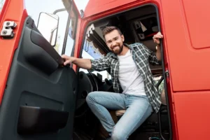 Man in red truck happy about his affordable truck loan interest rate